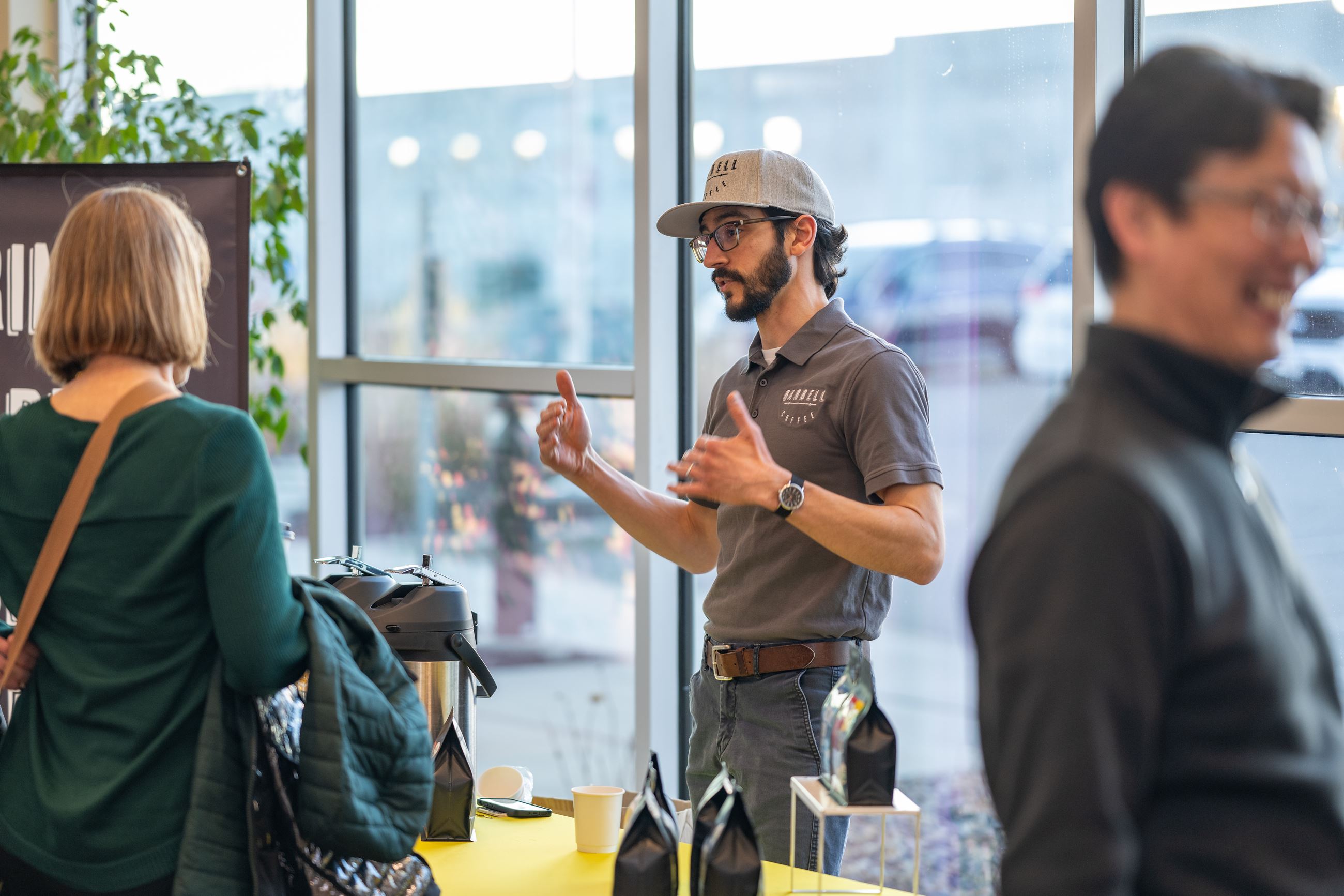 Barbell Coffee owner talks coffee with a guest